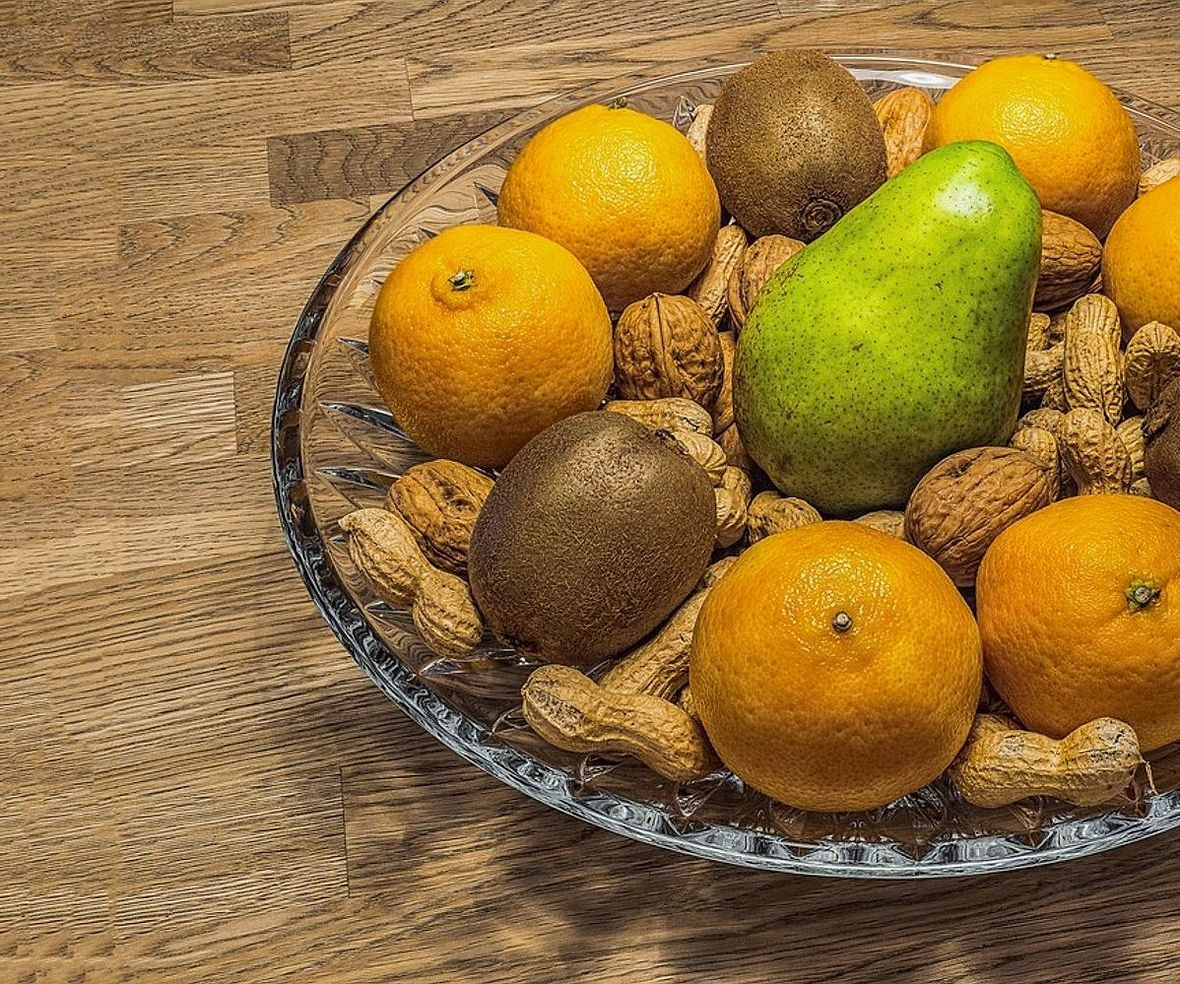 Hands selecting ripe fruit for your delivery box